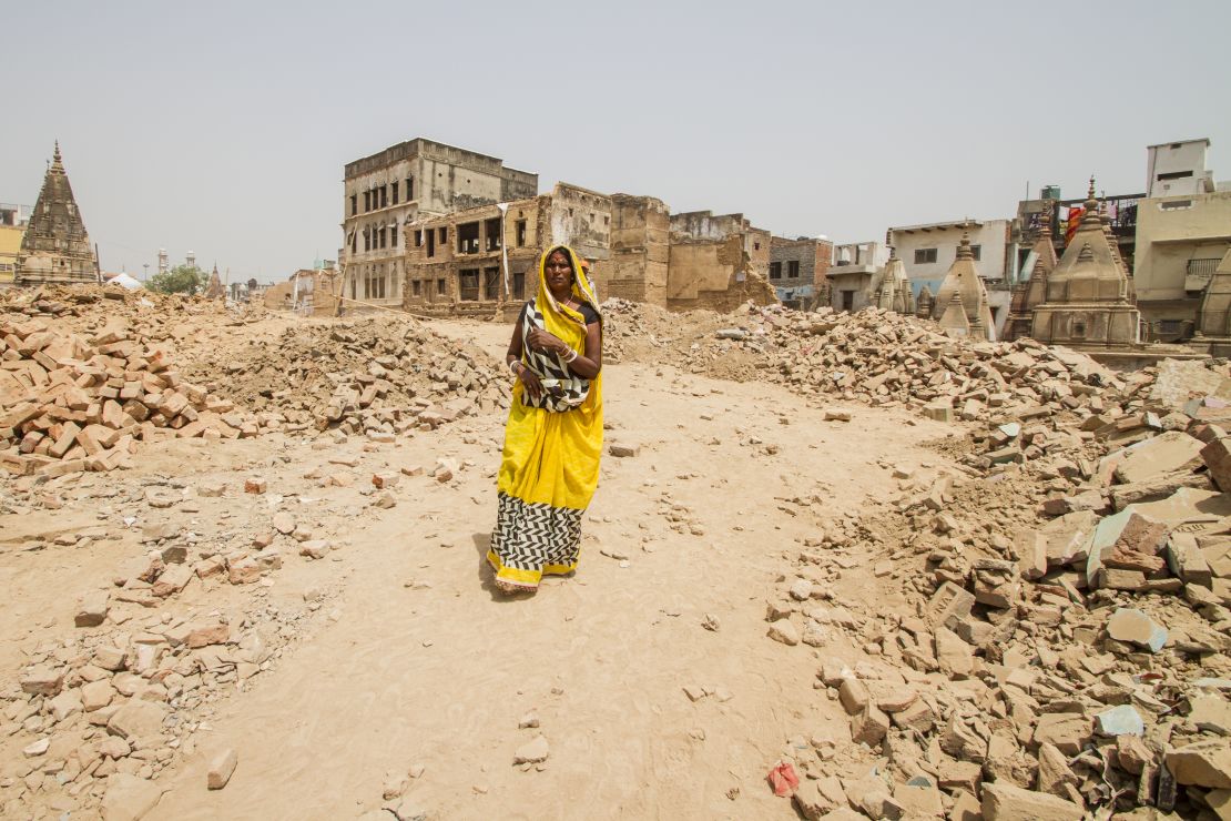 A woman walks through a demolition site, where buildings have been cleared to make way for the Kashi Vishwanath temple corridor in Varanasi.