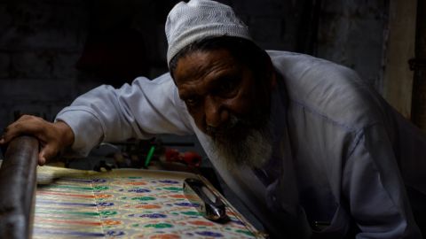 Hanif Babu and some of the intricate silk finery he and his family make.