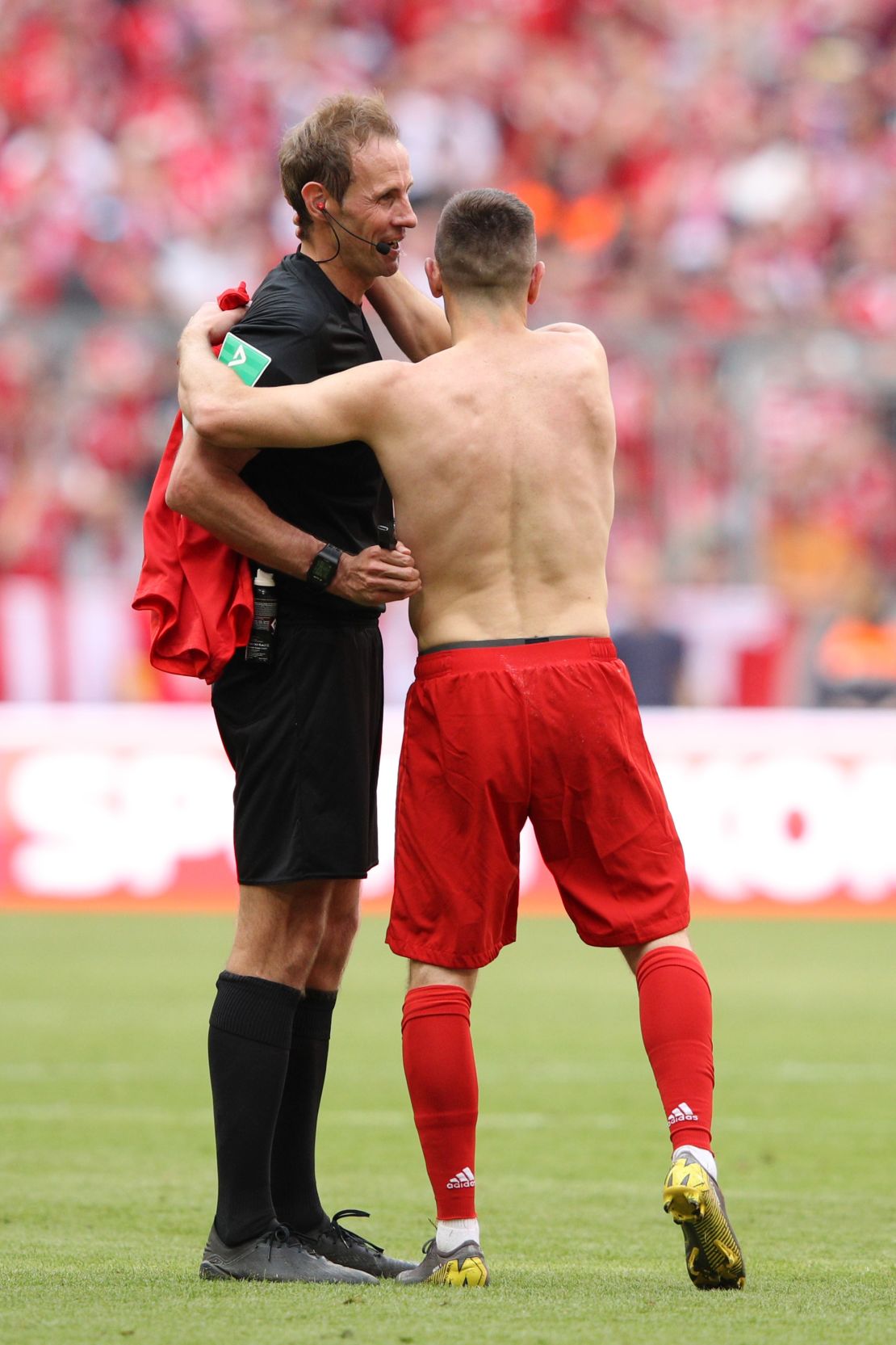 Franck Ribery hugs referee Sascha Stegemann after being shown a yellow card.