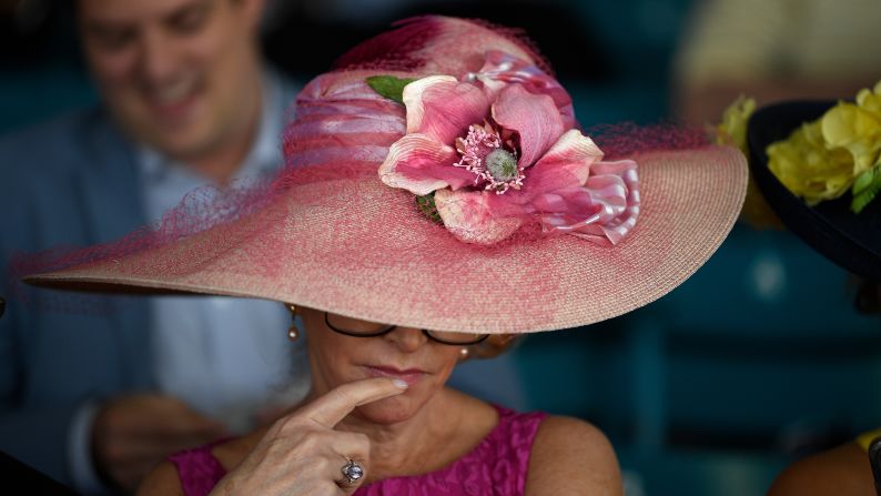 A spectator looks over a form ahead of the 144th Preakness Stakes horse race at Pimlico Race Course Saturday.