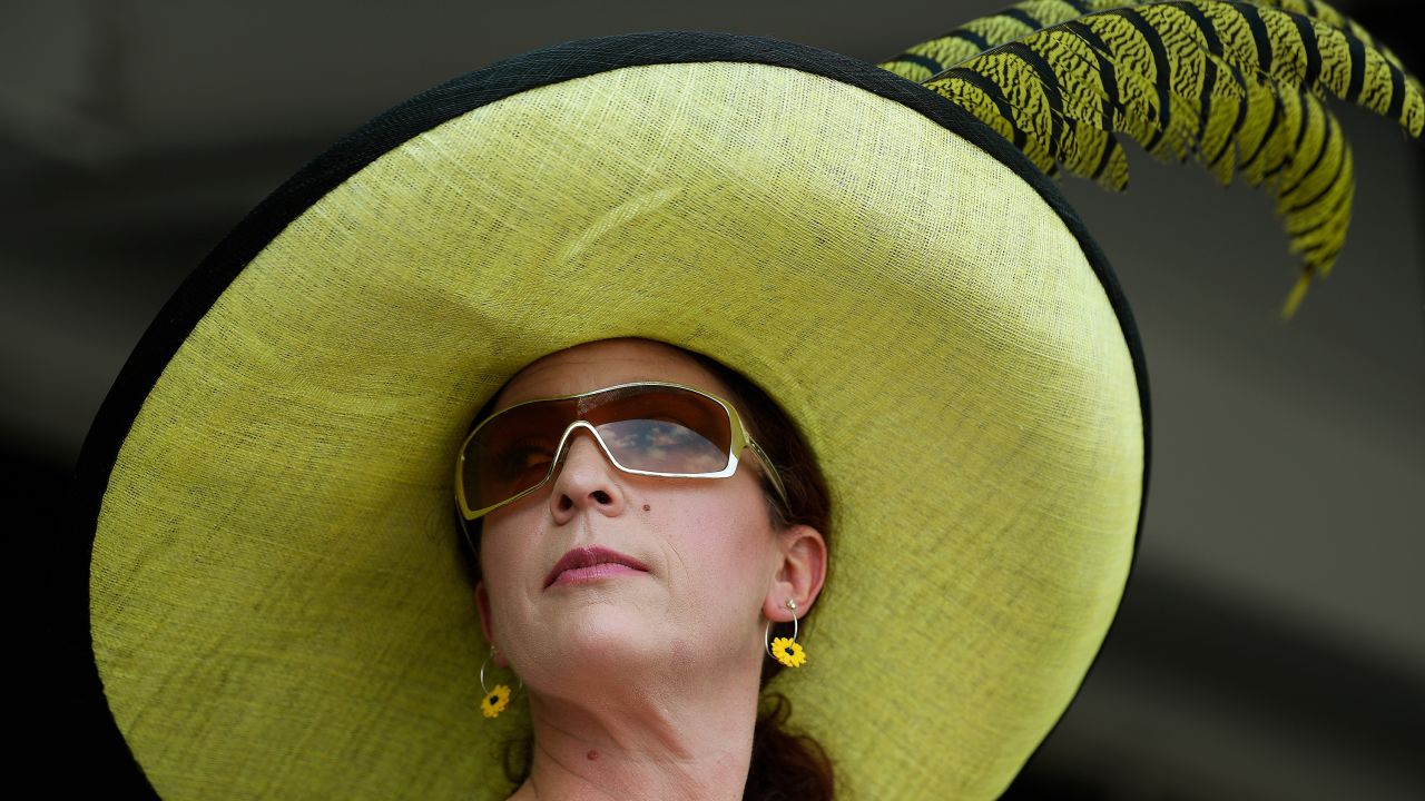 Collette Tipton of Baltimore watches race 6 ahead of the 144th Preakness Stakes horse race at Pimlico Race Course.