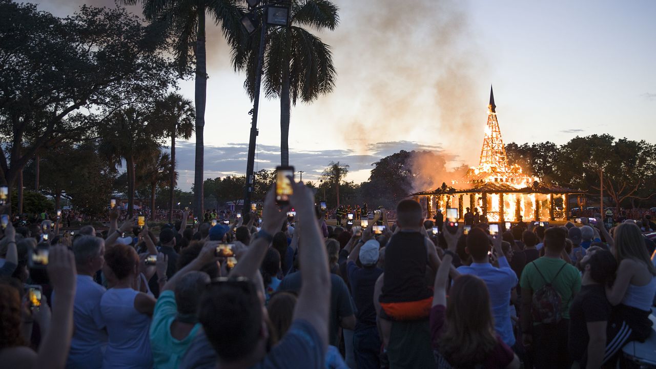 Crowds watch as a temporary art installation burns Sunday in Coral Springs, Florida. 