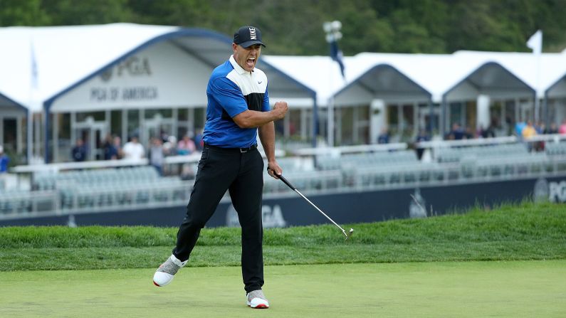 Brooks Koepka celebrates on the 18th green after making his putt to win the 101st PGA Championship at Bethpage Black on Sunday, May 19 in Farmingdale, New York. Koepka, who has now won <a href="index.php?page=&url=https%3A%2F%2Fwww.cnn.com%2F2019%2F05%2F19%2Fsport%2Fus-pga-day-four-brooks-koepka-bethpage-spt-intl%2Findex.html" target="_blank">four major championships</a>, is the first player since Tiger Woods (2006-2007) to successfully defend his title at the PGA.
