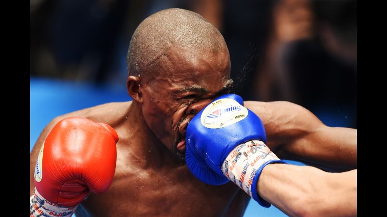 Moruti Mthalane of South Africa is punched by Masayuki Kuroda of Japan during their IBF flyweight title boxing bout in Tokyo on Monday, May 13.