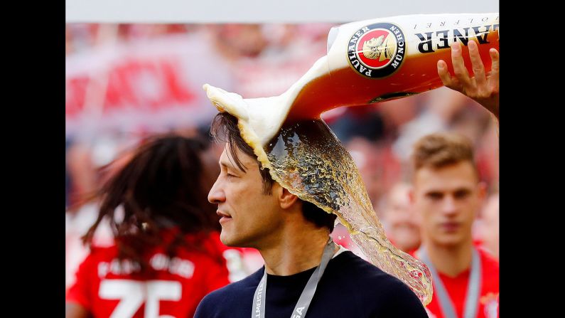 Bayern Munich player Arjen Robben pours beer on his coach Niko Kovac in celebration after defeating Eintracht Frankfurt to win the Bundesliga on Saturday, May 18 in Munich, Germany.