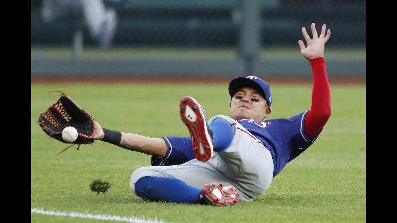 Texas Rangers left fielder Shin-Soo Choo misses a fly ball hit by Kansas City Royals' Alex Gordon during the first inning of a baseball game at Kauffman Stadium in Kansas City, Missouri on Tuesday, May 14.