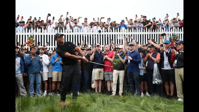 Tiger Woods plays a shot from the left rough of the first hole during the second round of the PGA Championship at the Bethpage Black on May 17 in Farmingdale, New York. Woods, who won the Masters Tournament in April, missed the cut.