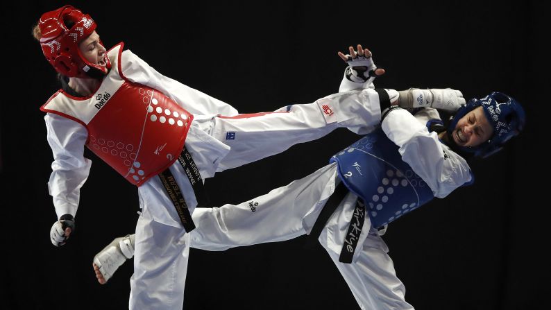 Rukiye Yildirim of Turkey, right, dodges a kick by Great Britain's Maddison Moore during their quarter final match on day three of the World Taekwondo Championships at Manchester Arena on Friday, May 17.
