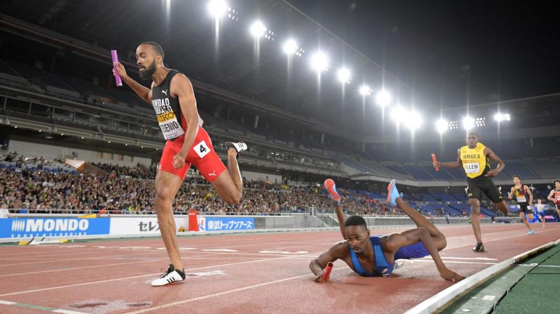 Paul Dedewo of the United States falls at the finish line attempting to beat Machel Cedenio (left) of Trinidad and Tobago during the 4 x 400m relay of the IAAF World Relays on Sunday, May 12 in Yokohama, Japan. The United States was disqualified.