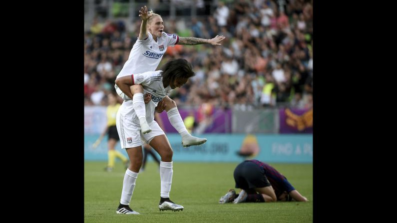 Jessica Fishlock of Olympique Lyonnais rides on the back of teammate Wendie Renard after defeating Barcelona 4-1 in the Women's Champions League final match in Budapest, Hungary on Saturday, May 18.