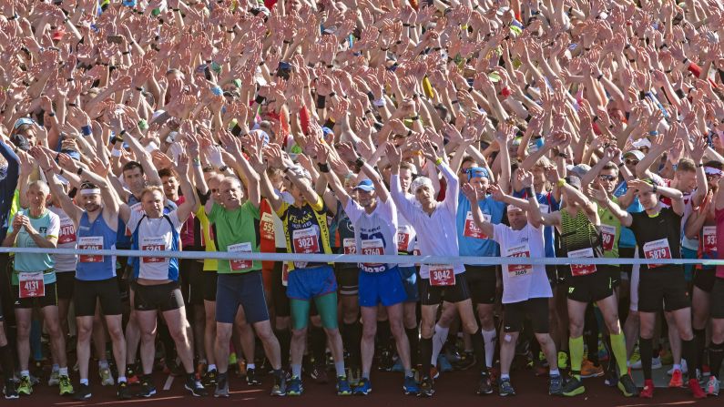 Thousands of runners wave and dance before the start of the GutsMuths-Rennsteiglauf cross country run in Neuhaus am Rennweg, Germany on Saturday, May 18. More than 16,000 runners participated in the race.