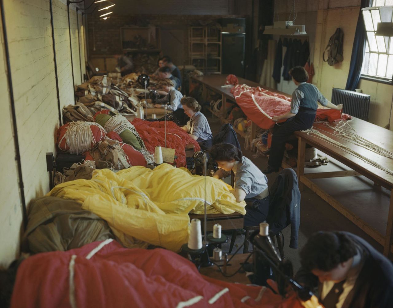 Members of the Women's Auxiliary Air Force (WAAF) repair and pack parachutes in May 1944. 