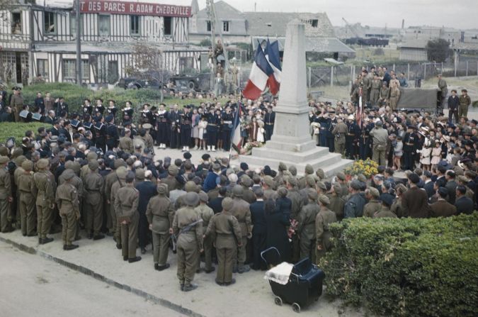 Celebrations for Bastille Day in Courseulles, on July 14, 1944. British and American troops join local inhabitants at the town's war memorial. Courseulles was one of the first towns to be liberated by the Allies. 