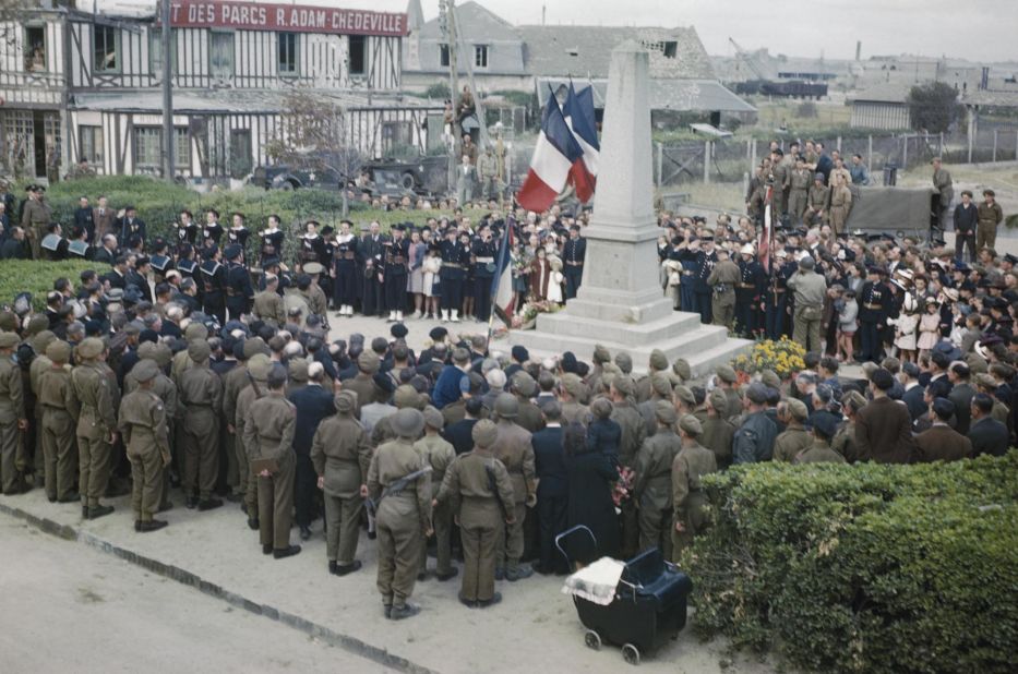 Celebrations for Bastille Day in Courseulles, on July 14, 1944. British and American troops join local inhabitants at the town's war memorial. Courseulles was one of the first towns to be liberated by the Allies. 