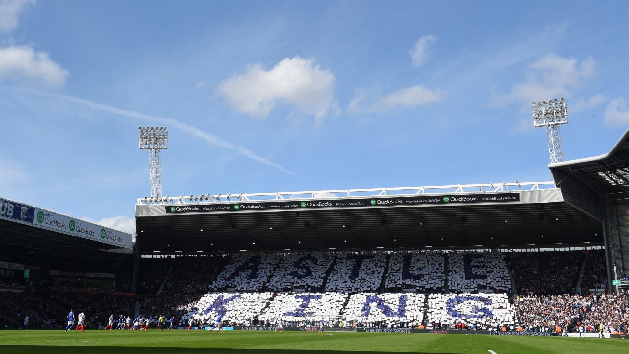 West Brom fans hold up cards in tribute to Jeff Astle.