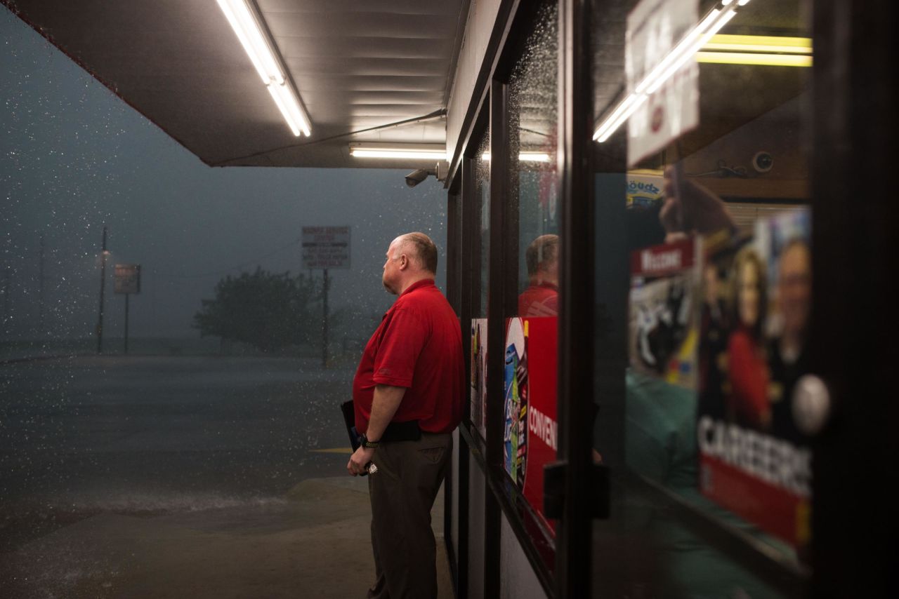 A worker at a gas station checks outside after a storm system passes in Perry, Oklahoma on May 20.