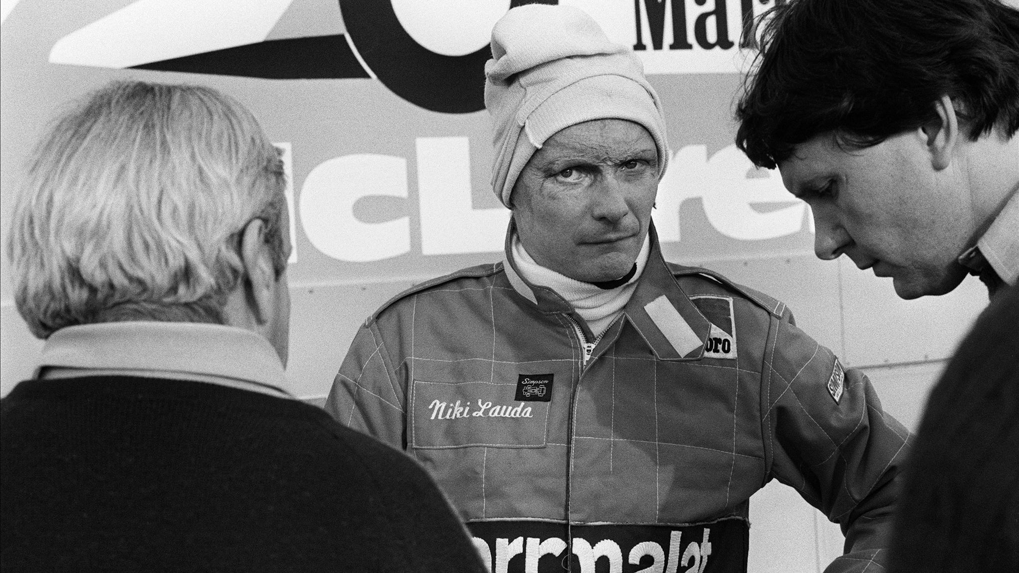 Lauda, center, talks to members of the McLaren racing stable on the Le Castellet racing circuit on November 20, 1981.