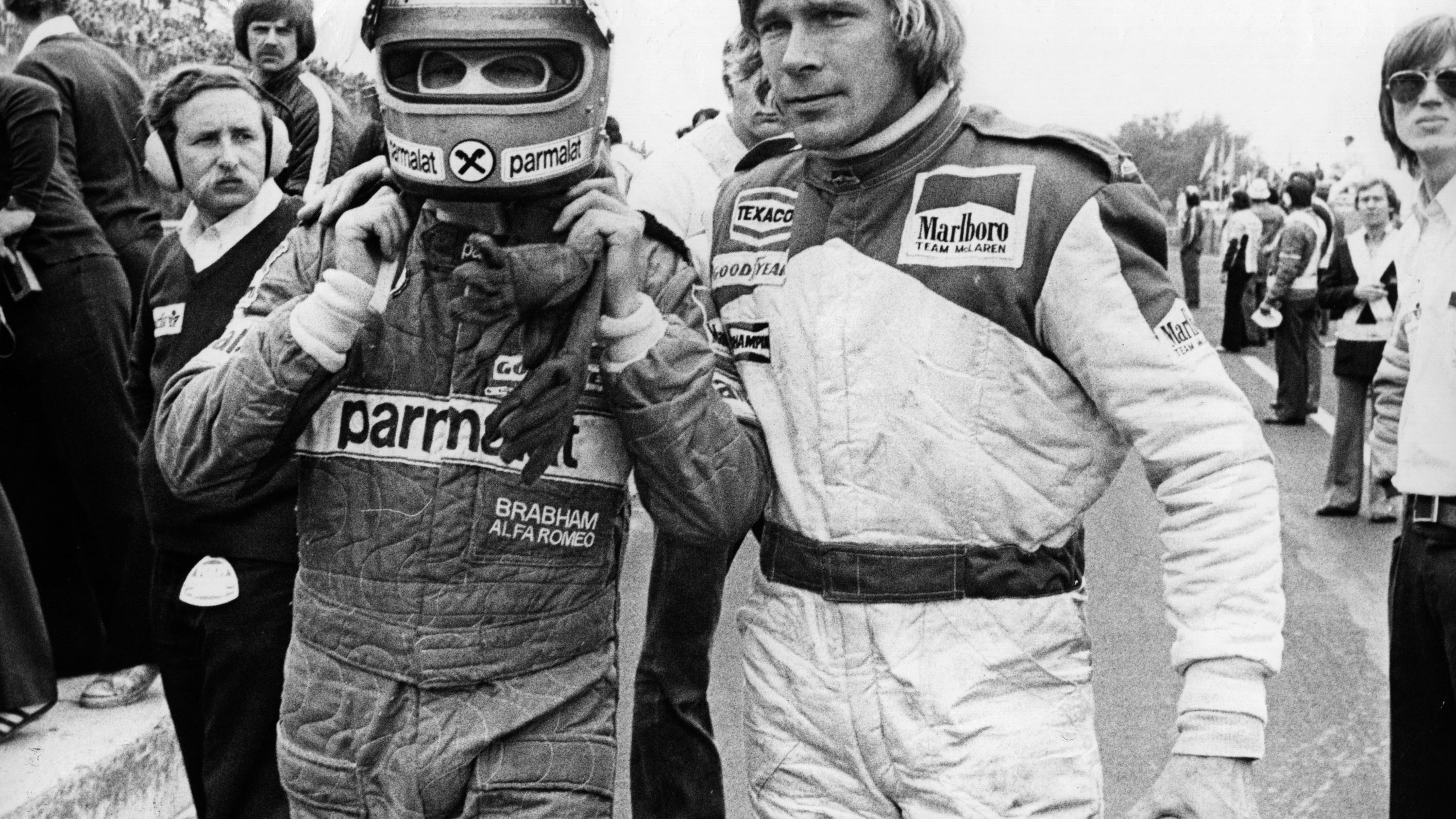 Lauda, left, and British racing driver James Hunt abandon a race after crashing into one other.