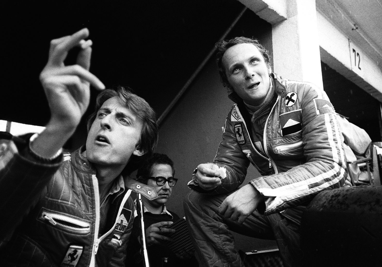 Lauda, right, sits with Ferrari race director Luca di Montezemolo.