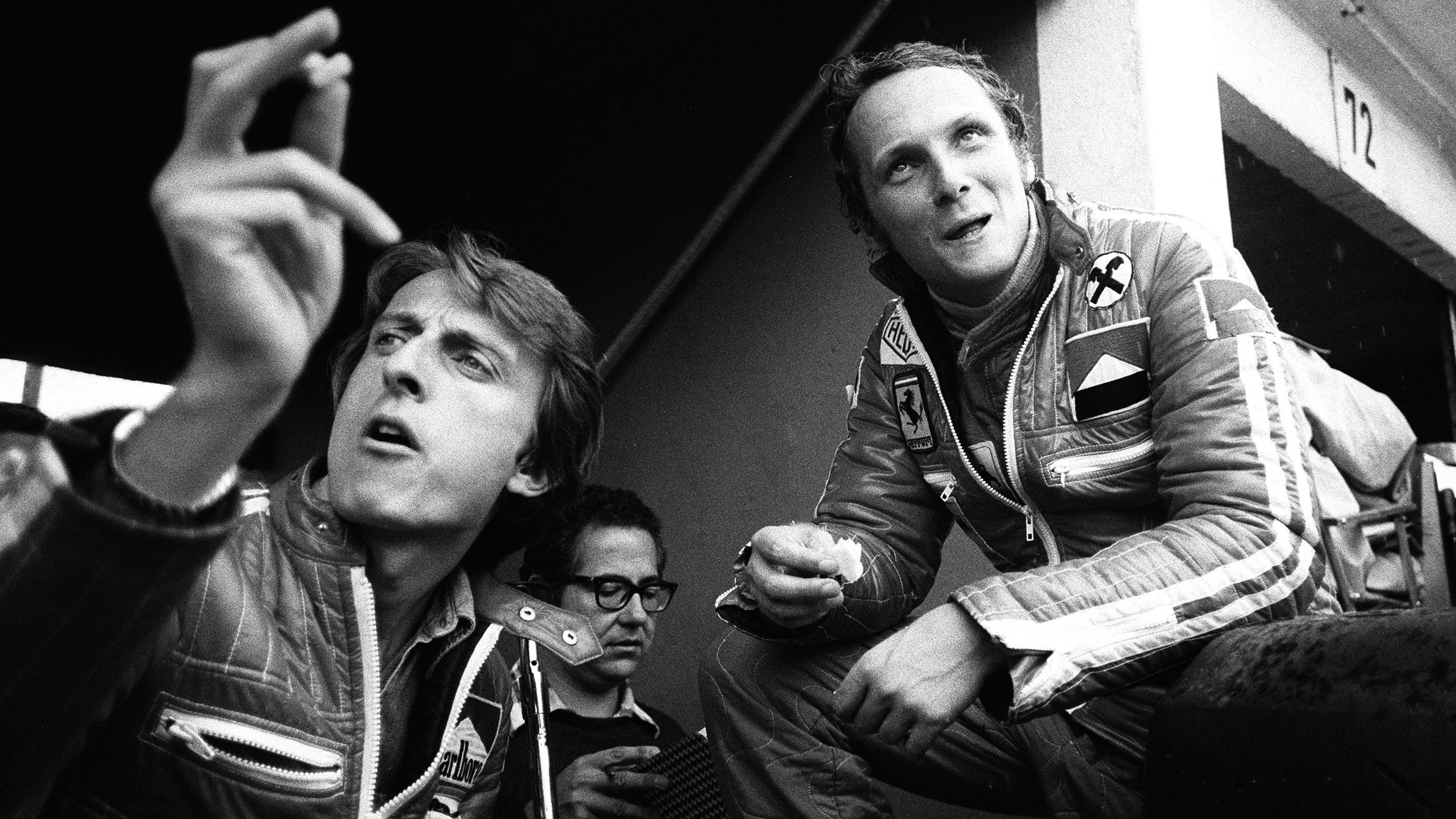 Lauda, right, sits with Ferrari race director Luca di Montezemolo.
