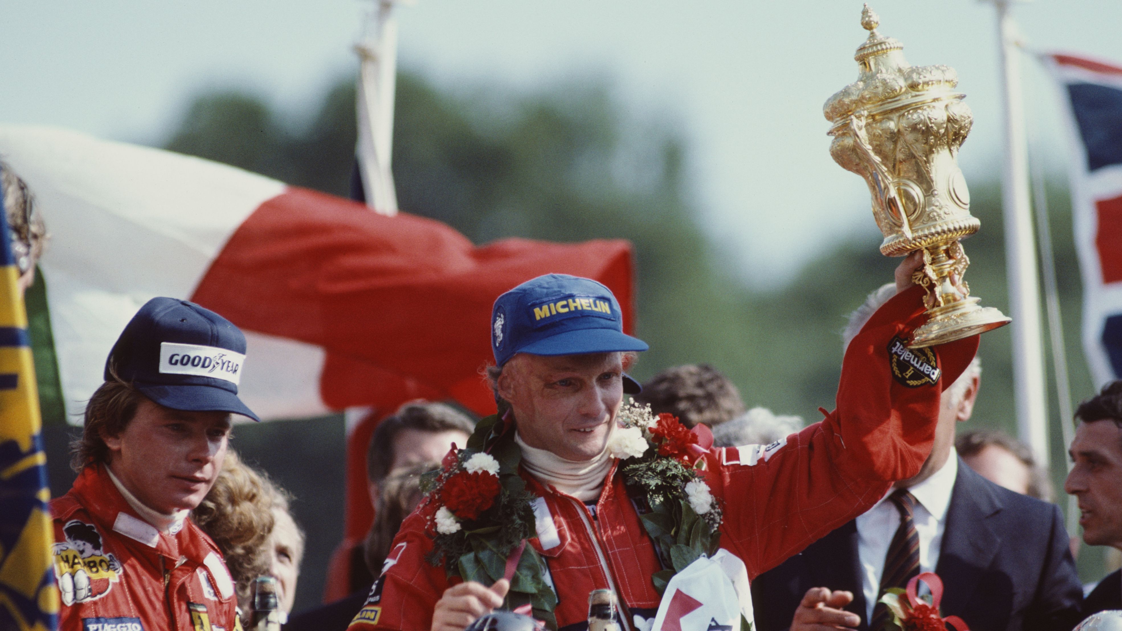 Lauda lifts the RAC Trophy and celebrates with second place finisher Didier Pironi after winning the Marlboro British Grand Prix on July 18, 1982 in Fawkham, England.