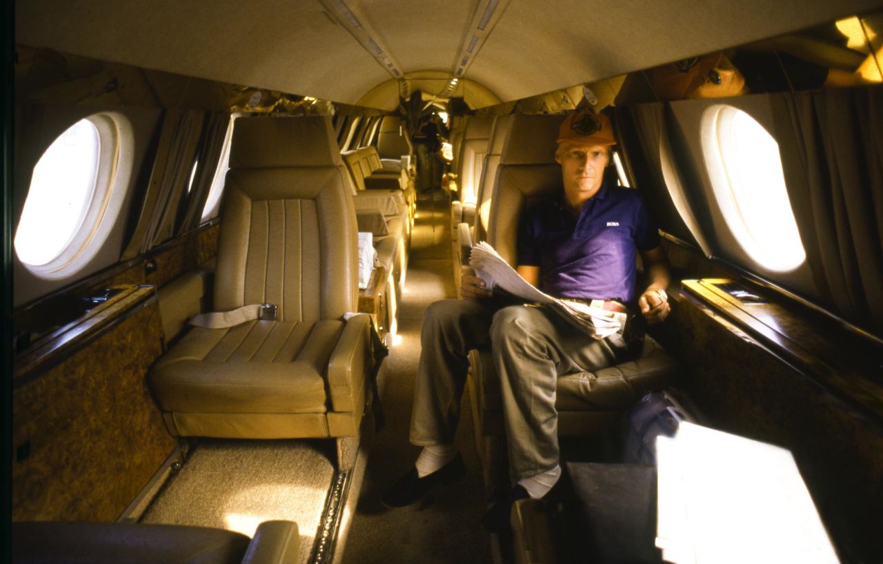 Lauda reads a newspaper on his private plane.