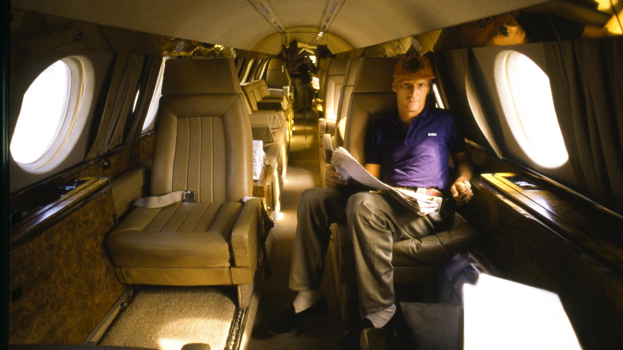 Lauda reads a newspaper on his private plane.