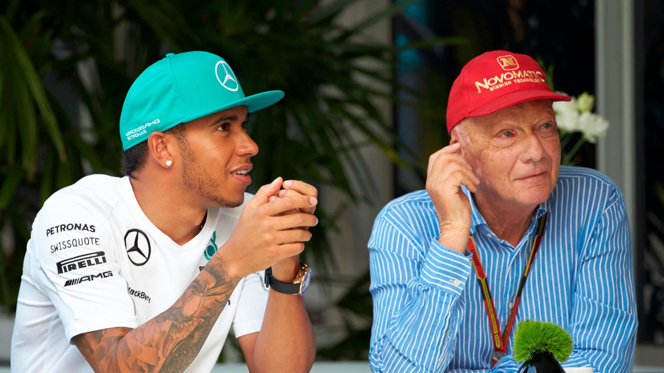 Lauda talks with Lewis Hamilton of Great Britain and Mercedes GP before practice for the Malaysia Formula One Grand Prix at the Sepang Circuit on March 28, 2014 in Kuala Lumpur, Malaysia.