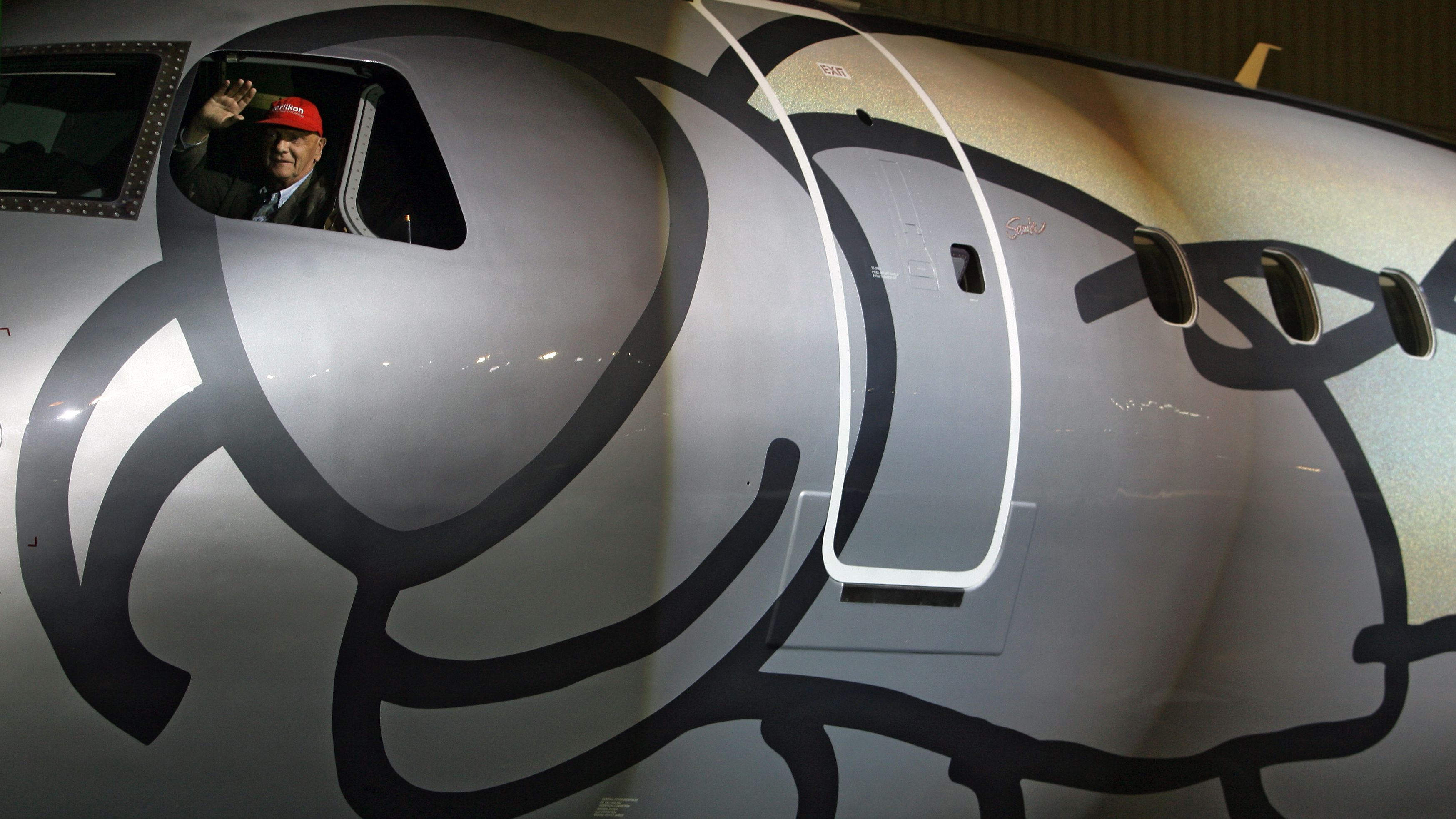 Lauda waves from the cockpit of the first 'Legacy 190' executive jet during a delivering ceremony to Niki airlines, at Embraer's headquarters, in Sao Jose dos Campos, north of Sao Paulo, Brazil, on May 14, 2009.