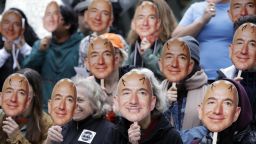 FILE - In this Oct. 31, 2018, file photo, demonstrators hold images of Amazon CEO Jeff Bezos near their faces during a Halloween-themed protest at Amazon headquarters over the company's facial recognition system, "Rekognition," in Seattle. San Francisco is on track to become the first U.S. city to ban the use of facial recognition by police and other city agencies as the technology creeps increasingly into daily life. Studies have shown error rates in facial-analysis systems built by Amazon, IBM and Microsoft were far higher for darker-skinned women than lighter-skinned men. (AP Photo/Elaine Thompson, File)