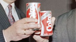 Robert C. Goizueta, Chairman of the Board and Chief Executive Officer, left, and Donald R. Keough, President and Chief Operating Officer, right, toast the New Coke after press presentation in Lincoln Center on April 23, 1985. (AP Photo/Marty Lederhandler)