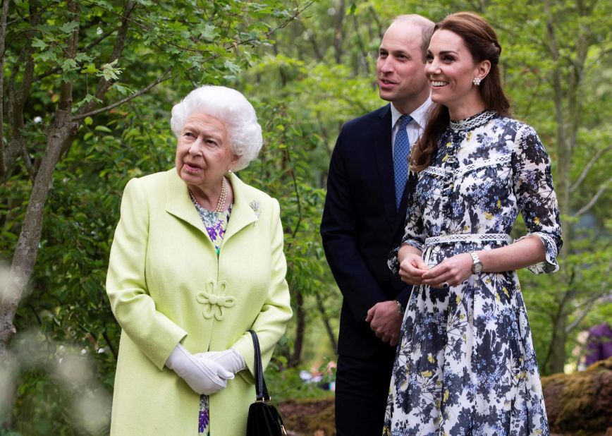Britain's Queen Elizabeth II, left, views the "Back to Nature Garden" with her grandson, Prince William, Duke of Cambridge, and his wife, Catherine, Duchess of Cambridge, who co-designed the display. Kensington Palace earlier <a href="https://edition.cnn.com/2019/05/19/uk/kensington-palace-royal-family-photos-trnd/index.html" target="_blank">shared some photos</a> of the duke and duchess playing in the garden with their young children.