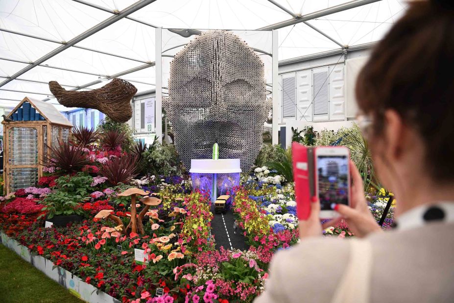 A visitor takes a photograph of a display entitled "Floella's Future," by Baroness Floella Benjamin.