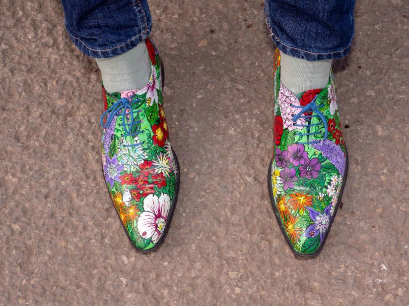 An exhibitor wears floral shoes on press day at the Chelsea Flower Show.