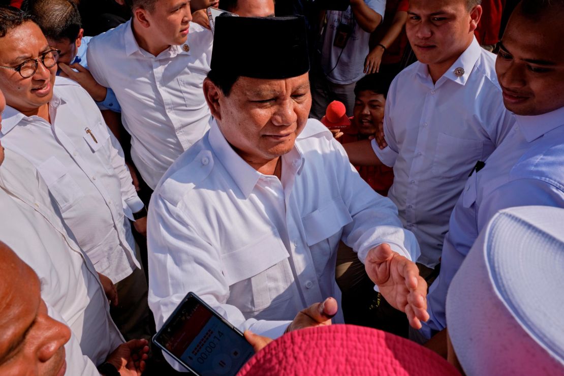 Indonesian Presidential candidate Prabowo Subianto shakes hands with voters after casting his vote at a polling station on April 17, 2019 in Babakan Madang, Indonesia. 