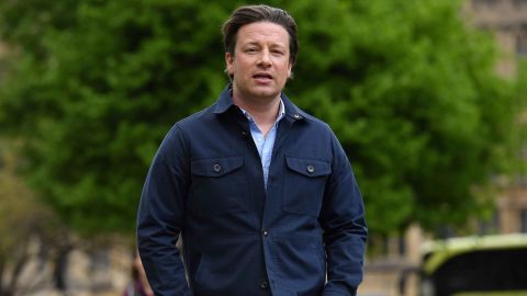 British chef and activist Jamie Oliver arrives to speak to members of the media after speaking on the subject of childhood obesity at Parliament's Health and Social Care Committee in London on May 1, 2018. (Photo by Ben STANSALL / AFP)        (Photo credit should read BEN STANSALL/AFP/Getty Images)