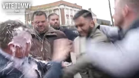 A grab from a Tommy Robinson promotional video on Youtube shows Robinson getting 'milkshaked.'