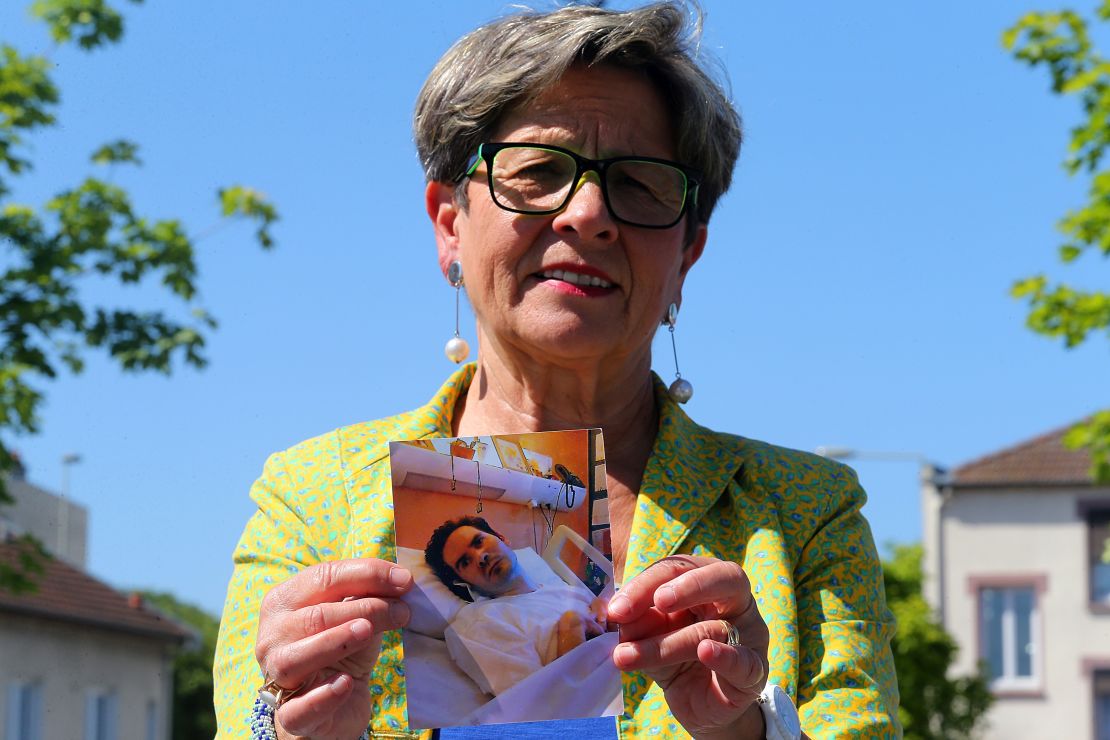 Viviane Lambert, Vincent's mother, holds a picture of her son on life support in 2015.
