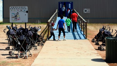 In this August 2018 photo provided by US Immigration and Customs Enforcement, immigrants enter a building at the South Texas Family Residential Center in Dilley, Texas.