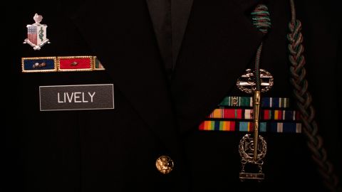 The badges and rank for Jordan Lively, a specialist in the US Army, are seen on his uniform.