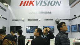 People visit the stand of Shenzhen-listed security camera manufacturer Hangzhou Hikvision Digital Technology during an expo in Nanjing city, east China's Jiangsu province, 11 April 2019. 