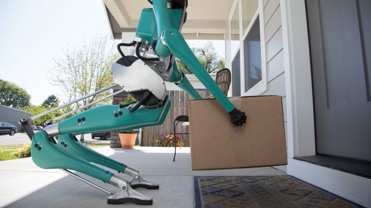 Ford's robot places a package in front of a door.