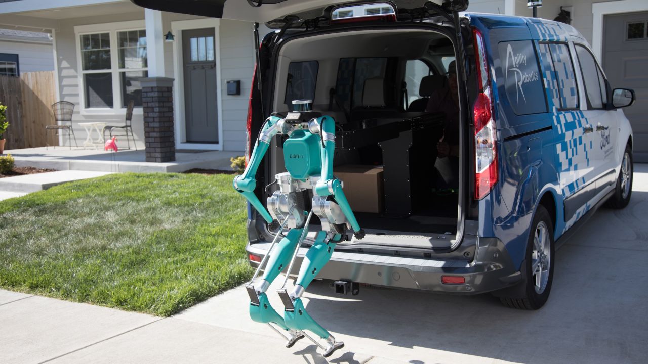 Ford's robot climbs out of a vehicle to make a delivery.