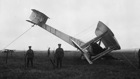 The airplane being guarded by troops after it landed in the bog.