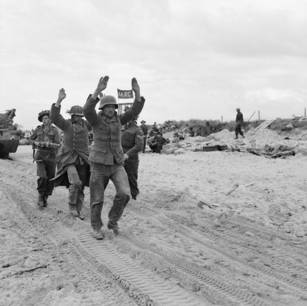 German prisoners are escorted along one of the Gold area beaches on D-Day.