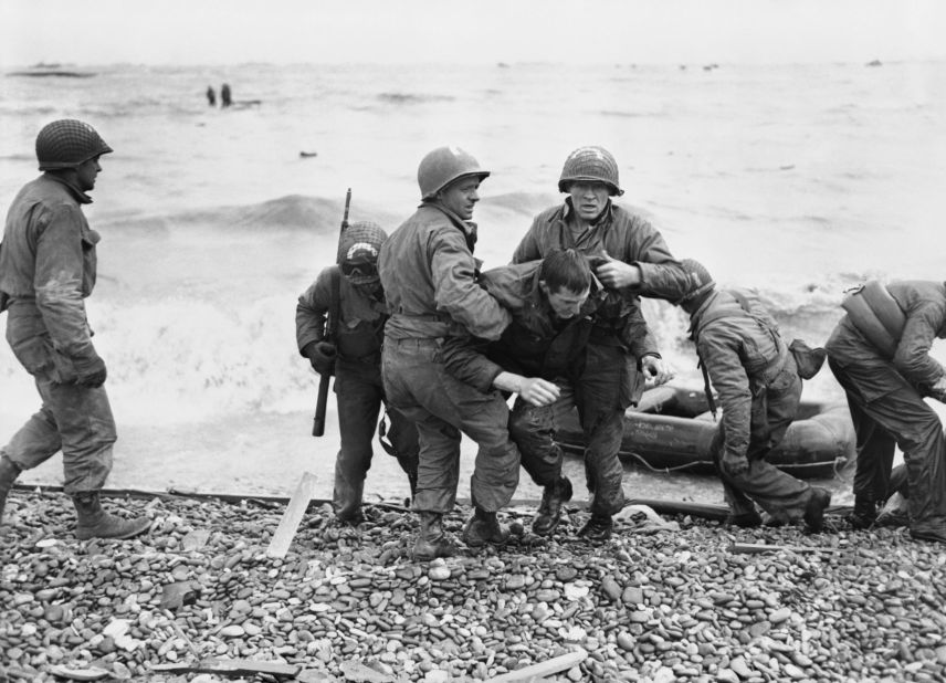 A survivor from a sunk American landing craft being helped ashore, Omaha assault area, on June 6.