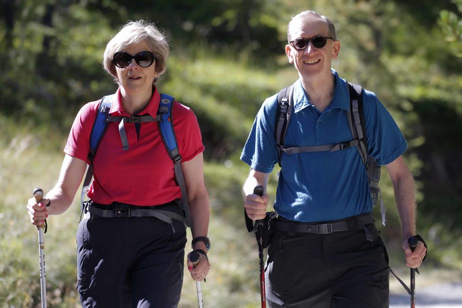 May walks with her husband, Philip, while they vacationed in the Swiss Alps in August 2016.