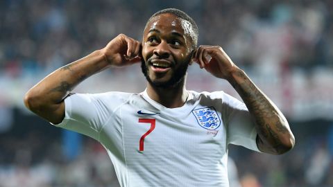 Raheem Sterling celebrates in the direction of Montenegro fans after being racially abused.