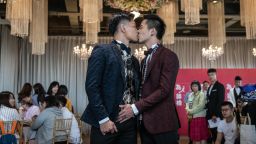 TAIPEI, TAIWAN - MAY 18: Gay couple A-Tuo (L) and Hsuan Yo kiss during a wedding event to raise HIV awareness a day after Taiwan's parliament voted to legalise same-sex marriage, on May 18, 2019 in Taipei, Taiwan. Taiwan yesterday became the first country in Asia to legalise same-sex marriage after lawmakers voted to allow same-sex couples full legal marriage rights, including areas in taxes, insurance and child custody. Thousands of gay rights supporters gathered outside the parliament building in the nation's capital as the result was announced. The bill will go into effect on May 24. (Photo by Carl Court/Getty Images)