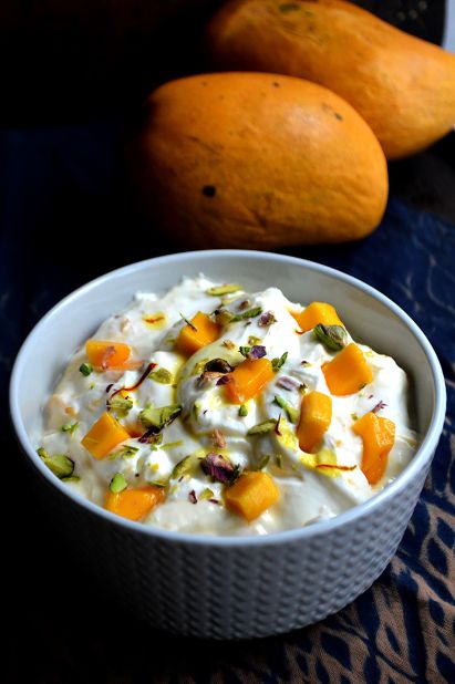 <strong>Shrikhand:</strong> It's made up of a thickened yogurt seasoned with green cardamom, sugar and saffron. This one is topped with fresh chunks of mango.